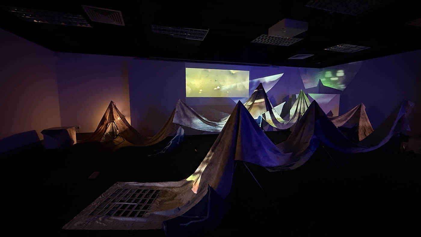 Figure 2: Video projection across the 28 x 1m calico, which was stained in sections by dipping it into the canal.